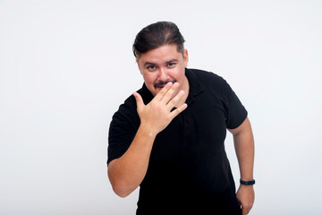 A middle aged man waves his hand, saying you can't see me. Isolated on a white background.