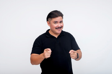 Smiling middle-aged man pointing forward in affirmation on a white background