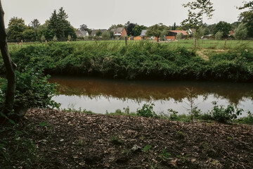 A small river meanders through the greenery of the park, creating a serene atmosphere