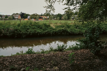 A small river meanders through the greenery of the park, creating a serene atmosphere