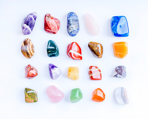 Semi-precious multi-colored stones, minerals on a white background close-up. Mineralogy. Collection of minerals.