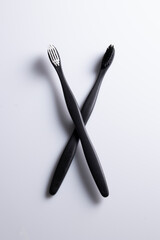 All black and white toothbrush isolated on a white background. Laid flat.