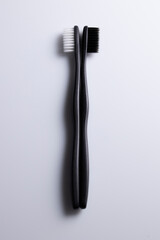 All black and white toothbrush isolated on a white background. Laid flat.