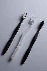 All black, white and combination of both toothbrushes isolated laid flat on a white background.