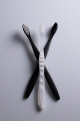 All black, white and combination of both toothbrushes isolated laid flat on a white background.