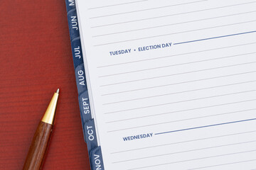 Empty day planner with Tuesday Election Day and pen on desk