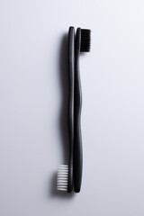 All black and white toothbrush isolated on a white background. Laid flat.