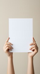 Female hands hold a blank sheet of paper on a beige background. Advertising space