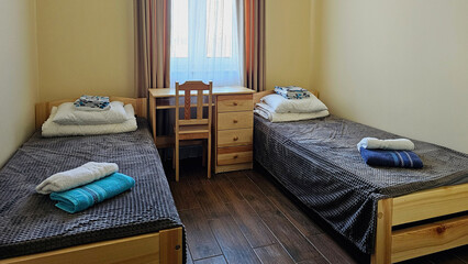 Double guest room with two single beds for a short overnight stay on a trip. Roadside motel apartment. Living space design
