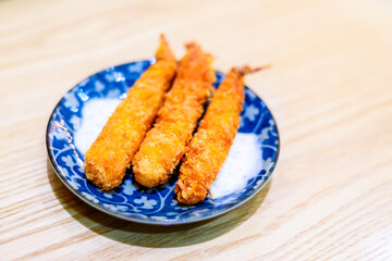 Golden Crispy Breaded Shrimp on Traditional Blue and White Porcelain Plate