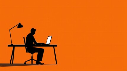 Silhouetted businessman working on laptop at minimalist orange workspace