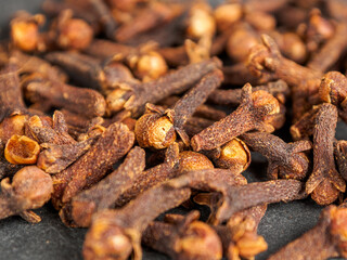 A close-up of aromatic cloves, highlighting the texture and rich color