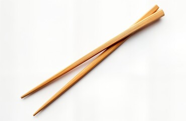 Wooden chopsticks isolated on white background. Traditional Asian eating utensils. Close up view of pair of chopsticks. Simple design. Clean and elegant. Natural material. Food tool.