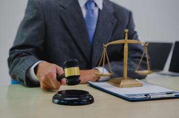 A dark-skinned Asian lawyer, dressed in professional attireon. provide legal advice, preparing cases in law office.