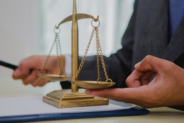 A dark-skinned Asian lawyer, dressed in professional attireon. provide legal advice, preparing cases in law office.