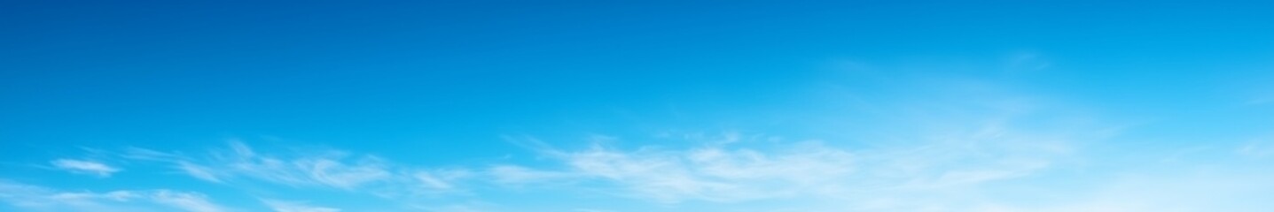 Serene gradient blue sky with few scattered clouds, creating a calm and tranquil atmosphere, perfect as a background for design projects and presentations.