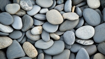 A close-up of flat sea pebbles stacked on each other, creating a peaceful and balanced composition.