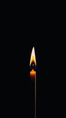 Fototapeta premium Burning candle radiates warm light in the darkness, crafting a serene and symbolic ambiance filled with hope, remembrance, and spirituality, inviting quiet reflection and tranquility