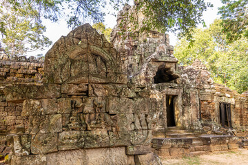 Ancient hindu Ta Som khmer  ruined temple entrance decorated with statues hidden in jungles, Angkor Archaeological Park, Siem Reap, Cambodia