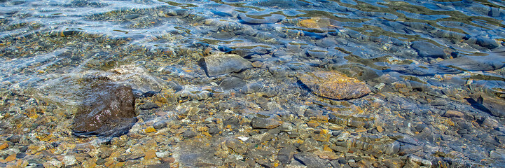 Transparent rocky shore beach detail, nahuel huapi lake, bariloche, argentina