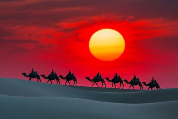 Fototapeta premium A serene caravan of camels marches across sweeping sand dunes under a vividly colorful sunset sky, casting long shadows in the tranquil desert landscape.