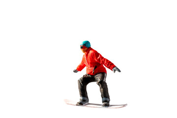Obraz premium Miniature figurine depicting a snowboarder in mid-motion isolate on white background with clipping path