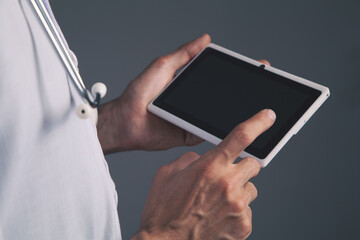 close up of doctor holding digital tablet in hands