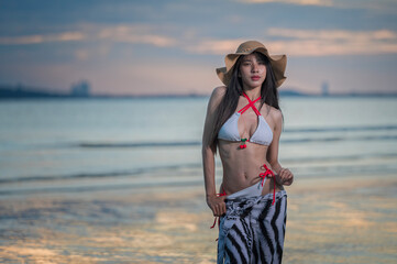 Portrait woman in bikini on the beach with Sunset