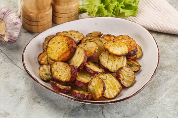 Baked red batat slices with herbs