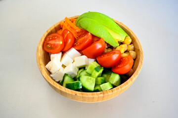Green salad with arugula, lamb and tomatoes. Healthy vegan dish. Top view at table. Turkish Coban (choban) salata or Shepherds salad, Akdeniz salad in white bowl.