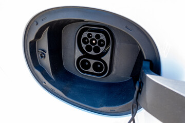 An electric vehicle (EV) charging high-voltage energy at an EV charging station replenishes its...