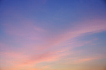 Early morning light sky before sunrise. Soft purple, pink and orange light on the horizon. Empty natural sky with colorful pastel tone colors for background. 
