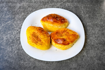 Turkish style meat stuffed filo dough borek served kol boregi.Cheese and minced pie are sliced on a marble background. Turkish name: Kol Boregi, kiymali, peynirli su boregi. Ci borek. Kafkas cig borek