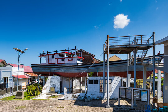 Banda Aceh, Indonesia - 12.26.2024: Aceh 2004 Tsunami monument, a ship on the roof of the house in Banda Aceh, Sumatra, Indonesia