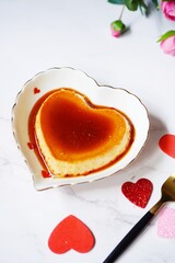 Heart shaped Creme caramel pudding or Caramel flan - Valentines day dessert, selective focus