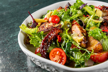 Vibrant mixed salad featuring fresh greens, cherry tomatoes, grilled chicken, and colorful vegetables. Perfect for healthy eating or fresh dining inspiration.