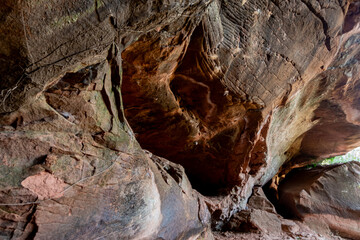 The Naga Cave in Bueng Kan, Thailand, features serpent-like rock formations tied to Naga mythology,...