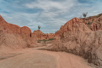 ochre canyons of the tatacoa desert on a sunny day with partial clouds