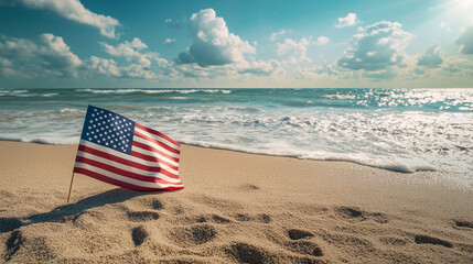 American flag on sandy beach during Memorial Day celebration by the ocean. 