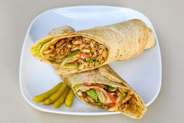 Lavash doner kebab ( soslu kasarli zurna doner durum )  or shawarma sliced in plate isolated. ...