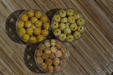 Assorted Indonesian Kue Nastar Cookies in Clear Containers on Bamboo Mat
