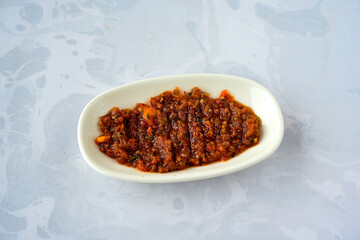 A spicy Turkish appetizer ezme made with tomatoes, bell pepper, parsley, mint, olive oil and hot chili. A kind of adjika. Kahvaltilik acuka, Antep usulu acili ezme.