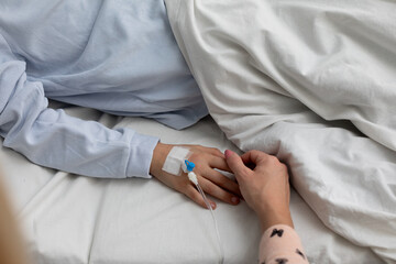 Tender Moment Holding Hands in a Hospital Setting to Offer Comfort and Emotional Support
