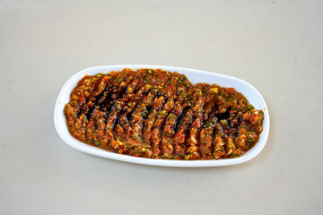 A spicy Turkish appetizer ezme made with tomatoes, bell pepper, parsley, mint, olive oil and hot chili. A kind of adjika. Kahvaltilik acuka, Antep usulu acili ezme.