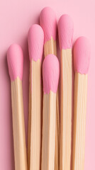 Fototapeta premium Pink-Dipped Wooden Matches on Pink Background