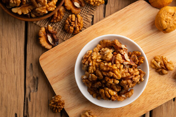 Walnut kernel and whole walnuts on a plate.Healthy Fats,Support weight management.Top view.