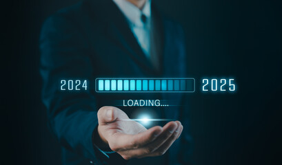 Progress and transition from 2024 to 2025 concept. Businessman holding loading bar transitioning from 2024 to 2025, progress, future planning, and new year goals. annual planning and business growth