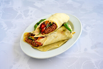 Grilled Turkish Adana, Urfa  Kebab with grilled vegetables, onion and rice on plate. Adana durum, Urfa durum .