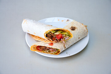 Grilled Turkish Adana, Urfa  Kebab with grilled vegetables, onion and rice on plate. Adana durum, Urfa durum .