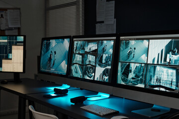 Fototapeta premium Workplace of absent officer of observation room with group of desktop computer monitors with cctv video system